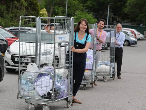 Flashback to 2020 - Fran Taylor from the Harrogate Scubbers with Dan Thirkell and Andrew Forsyth from Harrogate District Hospital with some of the scrubs sewed by the volunteers for staff.