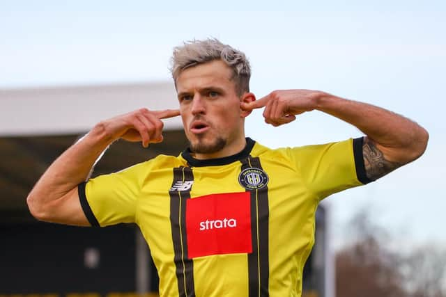 Josh March celebrates after netting Town's first-half equaliser against the Exiles.