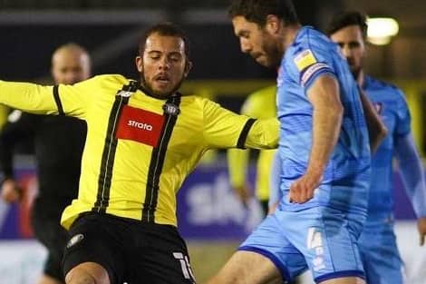Harrogate Town striker Aaron Martin competes for possession with Cheltenham's Ben Tozer. Pictures: Matt Kirkham