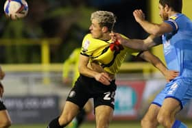 Harrogate Town striker Josh March tries to escape the attentions of Cheltenham skipper Ben Tozer. Pictures: Matt Kirkham