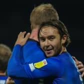 Dan Jones celebrates with team-mate Mark Beck following Harrogate Town's 1-0 win at Mansfield Town on November 24. The on-loan left-back has not played since. Pictures: Matt Kirkham