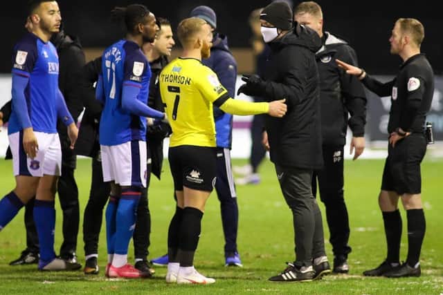 Players from both sides confront the match officials after December 29's clash between Harrogate Town and Carlisle United was abandoned after 10 minutes.