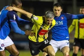 Harrogate Town striker Josh March looks to escape the attentions of two Carlisle United players. Picture: Matt Kirkham