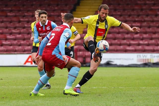 Town striker Aaron Martin keeps his eye on the ball.