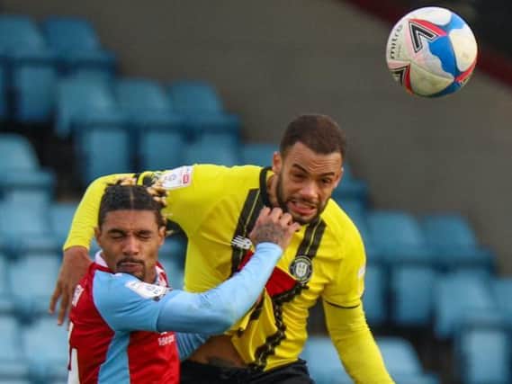 Harrogate Town right-back Warren Burrell beats Devarn Green to a header during his side's 3-1 loss at Scunthorpe United. Pictures: Matt Kirkham