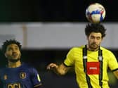 Harrogate Town centre-half Connor Hall heads the ball clear during his side's midweek win over Mansfield. Pictures: Matt Kirkham