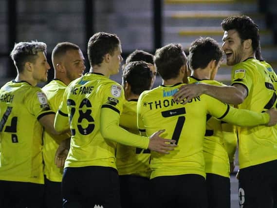 Harrogate Town players celebrate taking the lead against Mansfield Town on Tuesday night. They went on to win that game 1-0. Pictures: Matt Kirkham