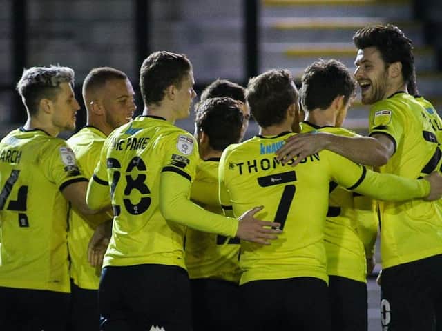 Harrogate Town players celebrate taking the lead against Mansfield Town on Tuesday night. They went on to win that game 1-0. Pictures: Matt Kirkham