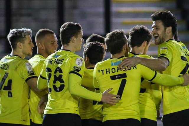 Harrogate Town players celebrate after taking a 1-0 lead against Mansfield Town in midweek.