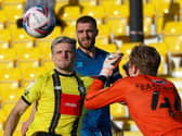 Josh March is beaten to the ball by Grimsby goalkeeper Jake Eastwood. Pictures: Matt Kirkham