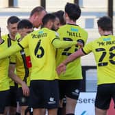 Harrogate Town players celebrate after Mark Beck handed them a 77th-minute lead against Grimsby Town. Pictures: Matt Kirkham