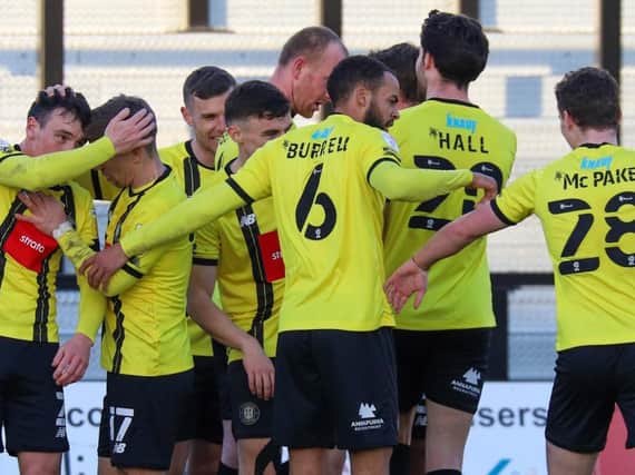 Harrogate Town players celebrate after Mark Beck handed them a 77th-minute lead against Grimsby Town. Pictures: Matt Kirkham