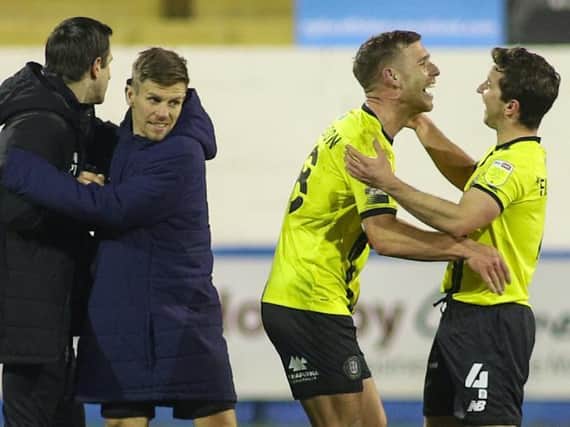 Harrogate Town celebrate three points after the final whistle at Barrow on Tuesday night. Josh Falkingham, right, came off the bench to set up the game's only goal for fellow substitute Jack Muldoon, second right. Pictures: Matt Kirkham