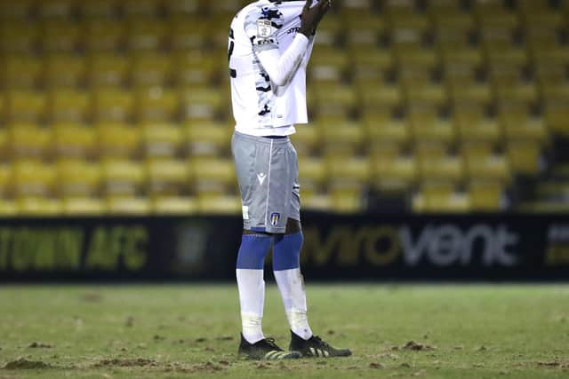 Colchester midfielder Brendan Sarpong-Wiredu hides his head after his team fall three goals behind.