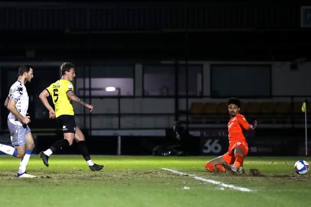 Will Smith slots home Harrogate Town's second goal of the game.