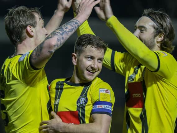Will Smith, left, is congratulated by team-mates Josh Falkingham and Dan Jones after putting Harrogate Town 2-0 against Colchester United. Picture: Matt Kirkham