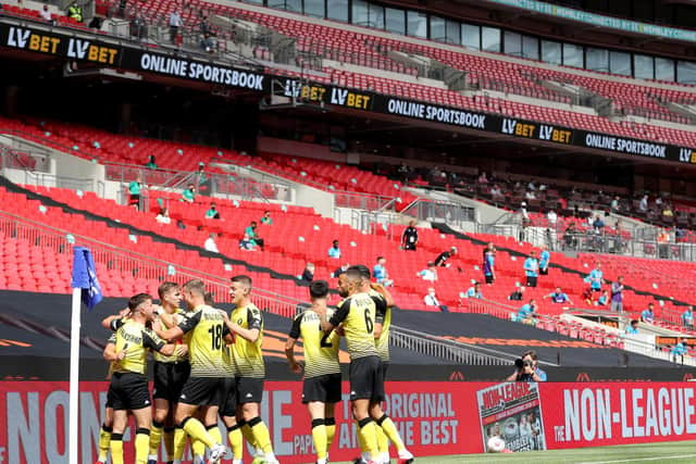 Harrogate Town's players celebrate after taking an early lead against Notts County at Wembley Stadium. Picture: Getty Images
