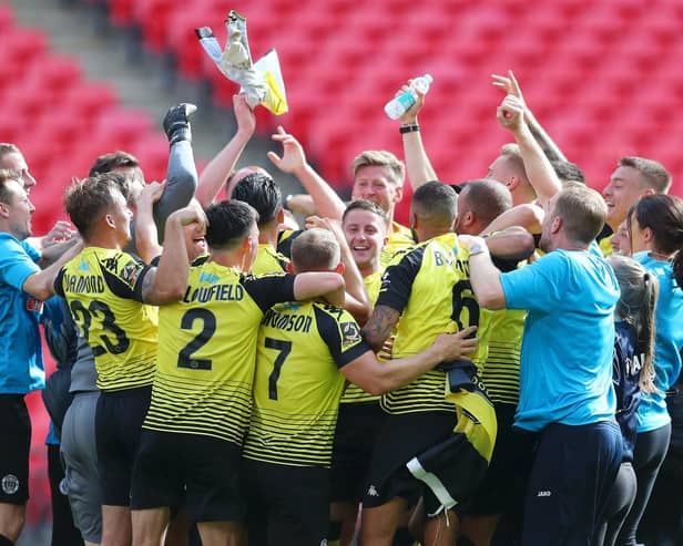 Harrogate Town players and staff celebrate on the Wembley turf following their 2019/20 National League play-off final success over Notts County. Picture: Getty Images