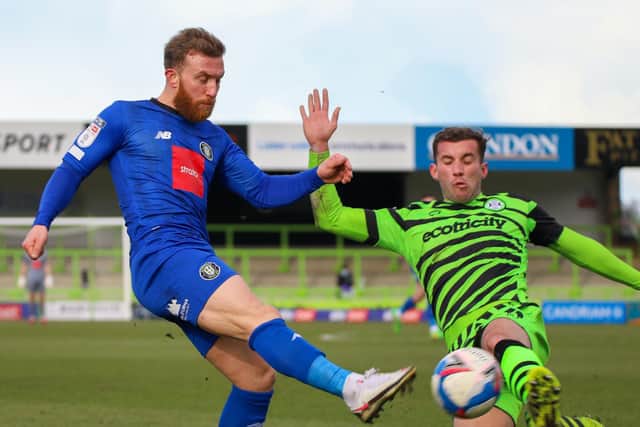 Sulphurites midfielder George Thomson is closed down by a Rovers defender.