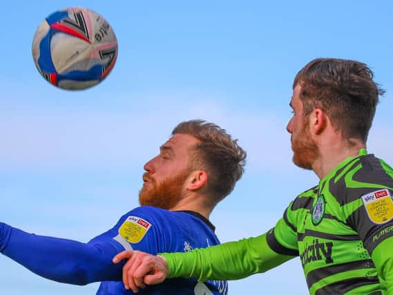 George Thomson challenges for a header during Harrogate Town's defeat at Forest Green Rovers. Pictures: Matt Kirkham