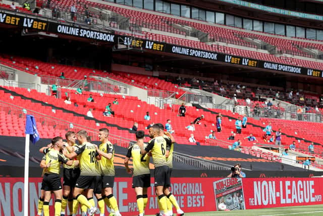 Harrogate Town's players celebrate taking an early lead against Notts County during the 2019/20 National League play-off final, a game that took place in front of a near-empty Wembley Stadium.
