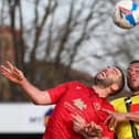 Harrogate Town striker Aaron Martin competes in the air with Morecambe's Alex Kenyon. Pictures: Matt Kirkham