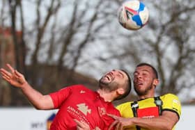 Harrogate Town striker Aaron Martin competes in the air with Morecambe's Alex Kenyon. Pictures: Matt Kirkham