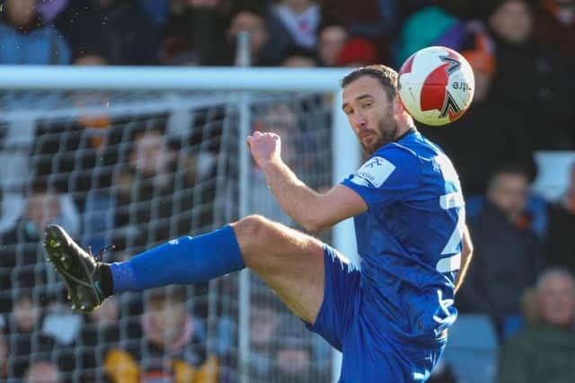 Rory McArdle heads clear during Harrogate Town's FA Cup third round defeat at Luton Town. Picture: Matt Kirkham