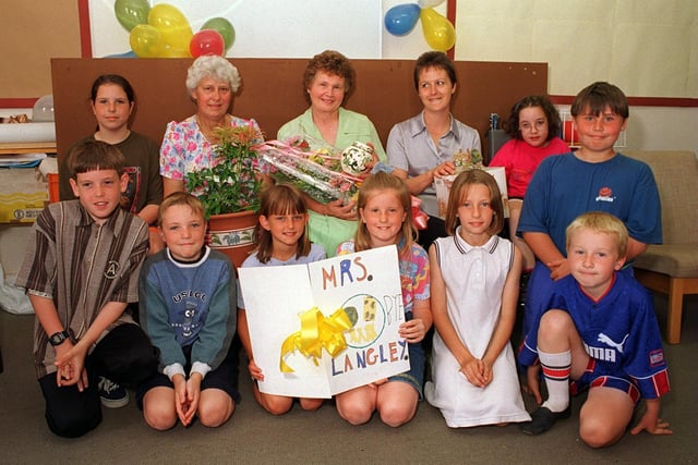 July 1997 and Dorothy Langley (pictured with flowers) was retiring from the kitchen at West Garforth Junior School after 20 years.