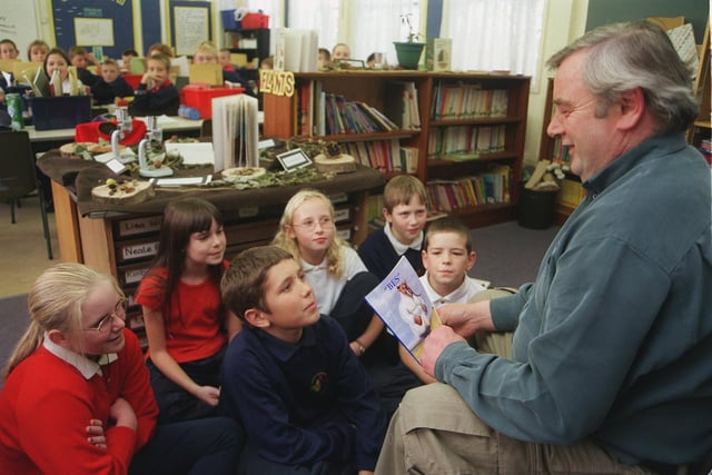 Writer Bill Ford is pictured with pupils of Class CA (Year 6) at West Garforth Junior School ion November 1999. He enjoyed a day with other class pupils learning about reading and writing with him.