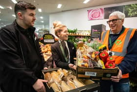 Marks and Spencer colleagues Louise and Ben with a charity partner who receive surplus food as part of the food redistribution scheme