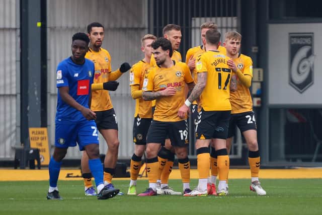 Harrogate Town midfielder Brahima Diarra cuts a dejected figure as Newport County celebrate one of their four goals during Saturday's League Two clash at Rodney Parade. Picture: Matt Kirkham