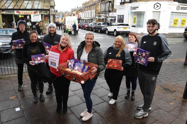 The sweetest Street in Harrogate? Pictured with chocolate donations on Commercial Street are traders Phil Dolby, Gemma Aykroyd, Kieran Sanderson, Sue Kramer, Alex Clarke, Andrea Godfrey, Carey Haegett and Bailey Parkyn. (Picture Gerard Binks)