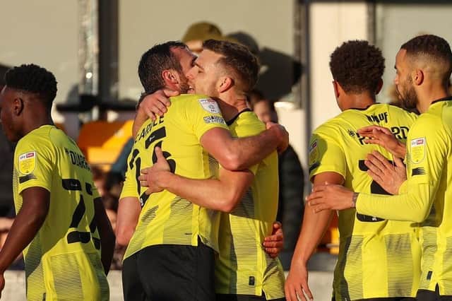 Jack Muldoon, centre, is congratulated after firing Harrogate Town into a first-half lead against Oldham Athletic. Pictures: Matt Kirkham