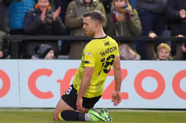 Harrogate Town attacker Jack Muldoon slides on his knees as he celebrates putting his side two goals up against Oldham Athletic. Pictures: Matt Kirkham