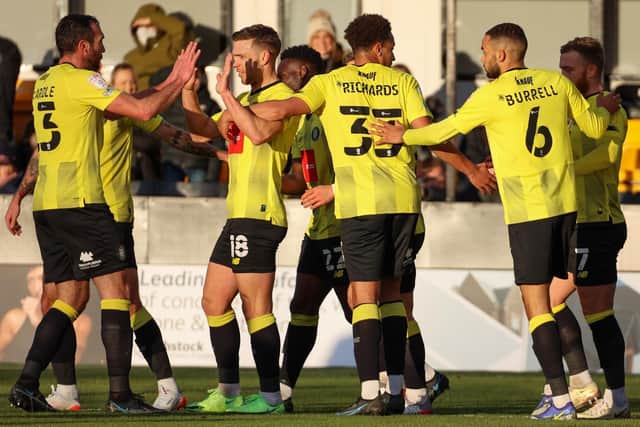 Lewis Richards joins in the celebrations as Harrogate Town's players enjoy taking an early lead through hat-trick hero Jack Muldoon's first of the afternoon.