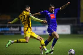 Harrogate Town defender Lewis Page is challenged by Sutton United's Joe Kizzi. Pictures: Matt Kirkham