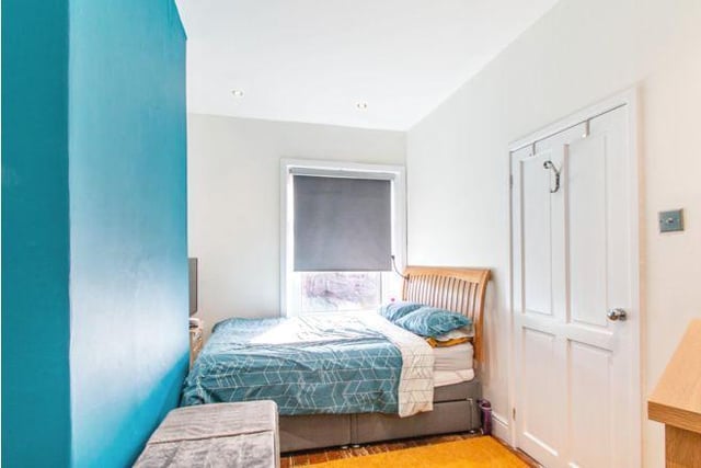 Upstairs are two bedrooms. This one is painted a bright turquoise to add fun into the room.