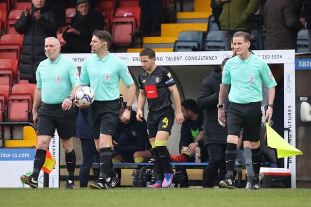 Referee Neil Hair, second left, leads the teams onto the field ahead of Saturday's League Two clash between Rochdale and Harrogate Town. Pictures: Matt Kirkham