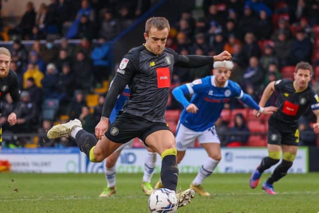 Alex Pattison converts a 24th-minute penalty to put Harrogate Town 2-1 up at Rochdale.