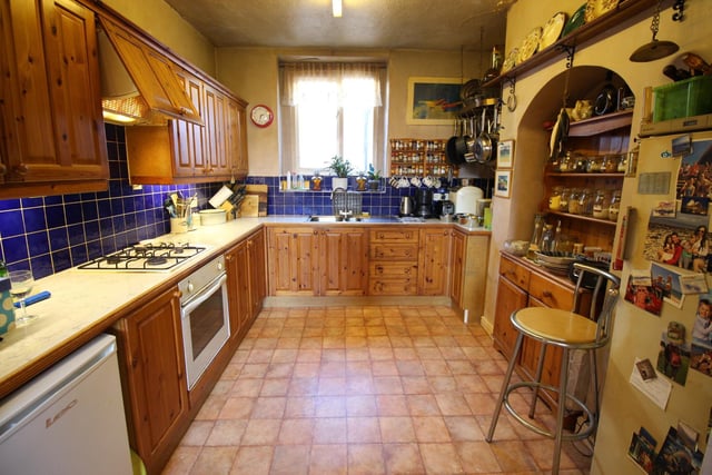 A large character kitchen with plenty of storage and integral appliances inside this Scarborough home. (Exterior top photo.)