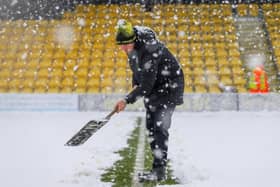 Harrogate Town staff and volunteers attempted to clear the EnviroVent Stadium pitch of snow ahead of Saturday's scheduled League Two fixture with Leyton Orient.  Pictures: Matt Kirkham