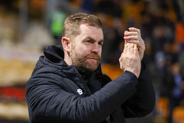 Harrogate Town manager Simon Weaver applauds the away fans at Valley Parade.
