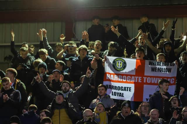 Harrogate Town supporters celebrate taking a 3-1 lead at Valley Parade.