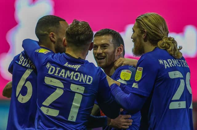 Harrogate Town players celebrate their first-half equaliser against Bradford City. Pictures: Matt Kirkham