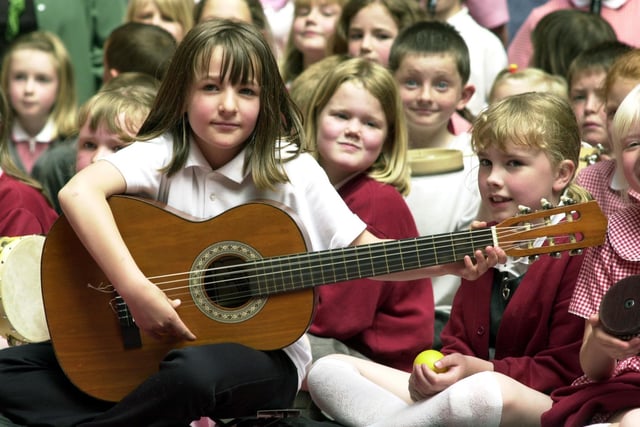 Guitarist Sophie Sadler, seven, with pupils of Hookstone Chase Primary School, taking part in creative music drama workshops at the Old White Swan Hotel.