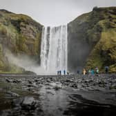 ICELAND: Tourists walk around Skogafoss waterfall. Photo: Getty Images