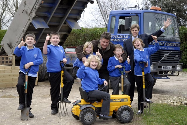 Stockdale Construction Ltd donates 12 tons of topsoil to Seamer and Irton Primary School for the new garden area planters. Pictured with the pupils are John Stockdale, director of Stockdale Construction, centre, and headmaster Jonathan Wanless, back.