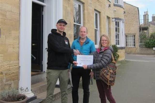 Penny Stables and Adrian Balcombe, who leads the Community Green Group’s Recycling and Reducing Food Waste group, present the 5 star Sustainability awards to Chris Impett, manager of The Crown.