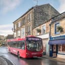 Photo: A Harrogate Bus Company vehicle driving through Pateley Bridge.